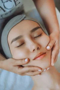 Lymphatic facial drainage massage focusing on jawline and chin area to stimulate circulation and reduce puffiness.